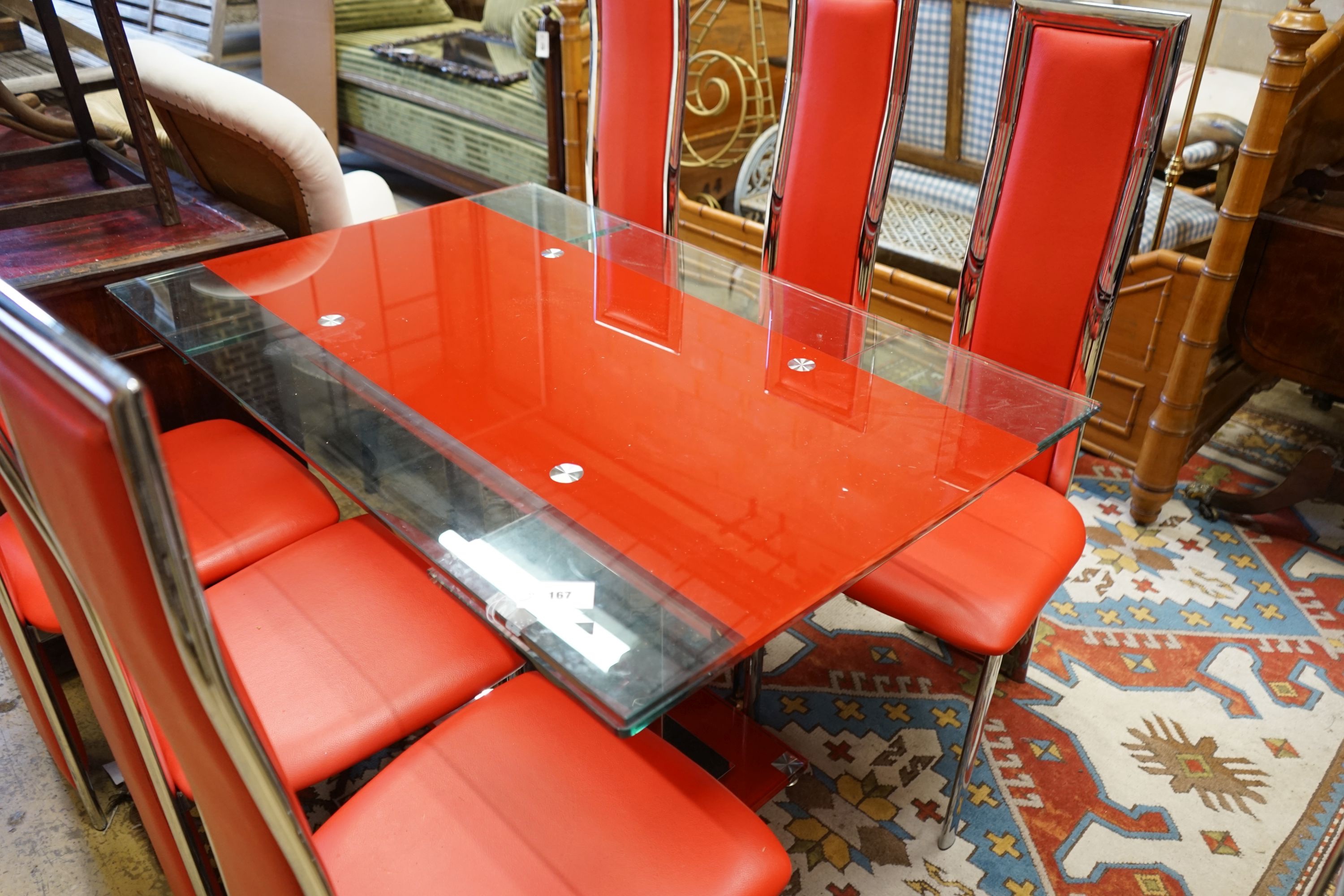 A set of red Italian design dining chairs and an associated chrome table, width unextended 120cm depth 80cm height 75cm